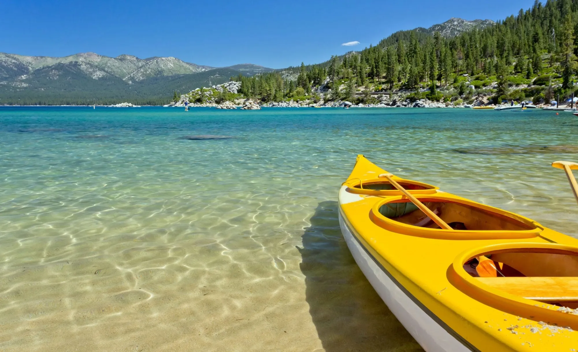 A yellow kayak on the clear water of Lake Tahoe